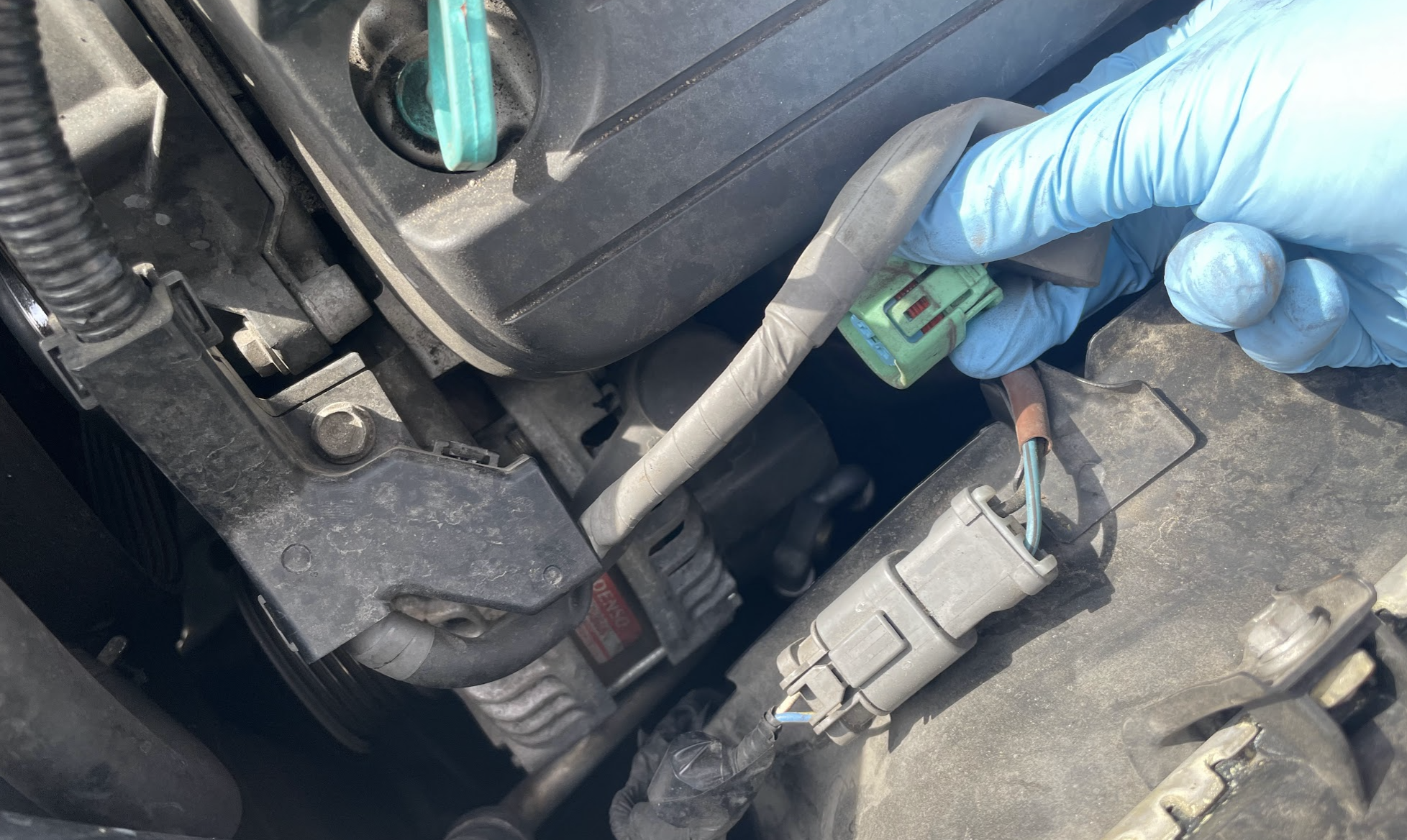 Disconnected harness plug with rubber boot pulled back